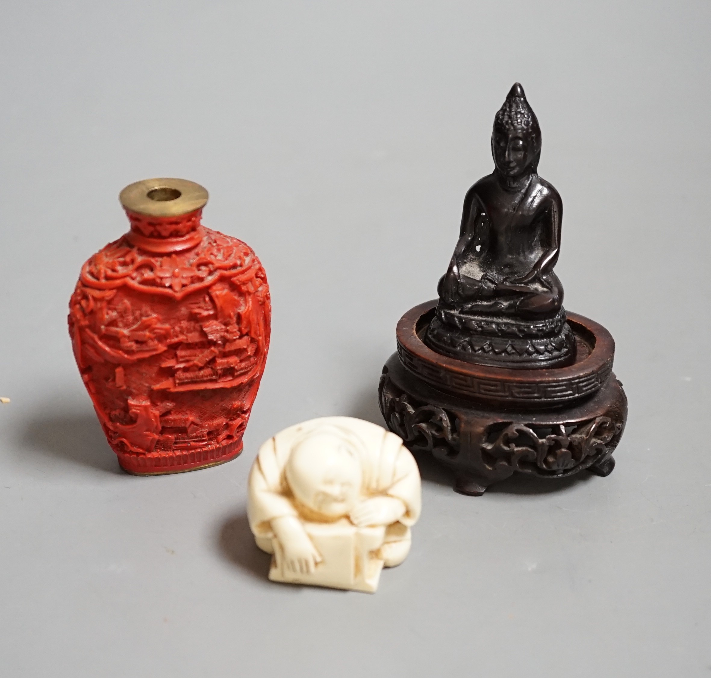 A Chinese resin snuff bottle, a resin Buddha on stand and a resin netsuke